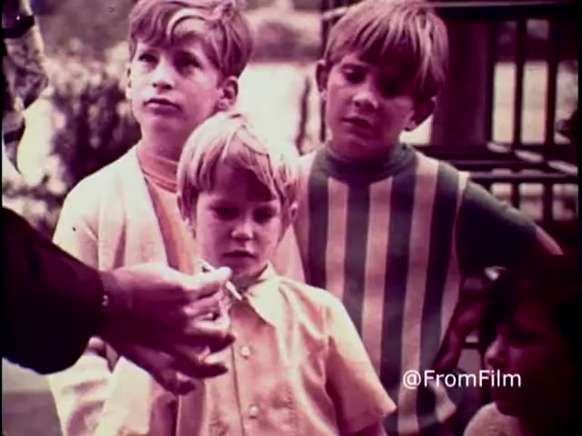 Depicts a young man sitting alone in a dimly lit room.